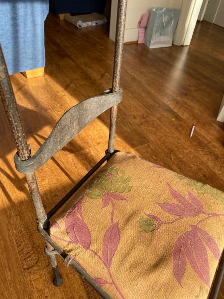 A chair with a high metal back.