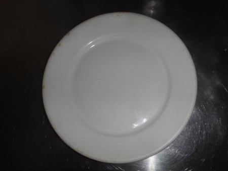 The front of a white china plate.