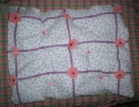 The front of a doll quilt.