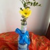 Fabric Covered Specimen or Bud Vase - greenery and a yellow flower in bottle with a blue ribbon tied to neck