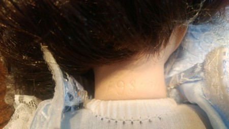 A marking on the back of a porcelain doll.