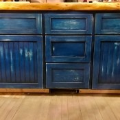 Cabinet doors and drawers painted a deep blue.