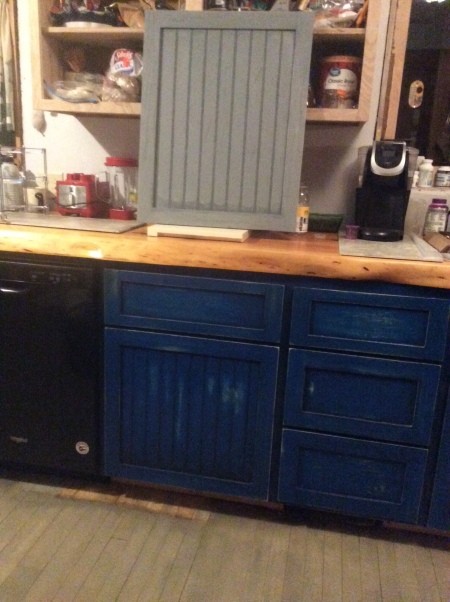 Grey top cabinets and blue bottom cabinets.