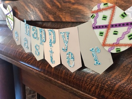 Happy Easter Banner - view from the right end of the banner hanging on a wood mantle