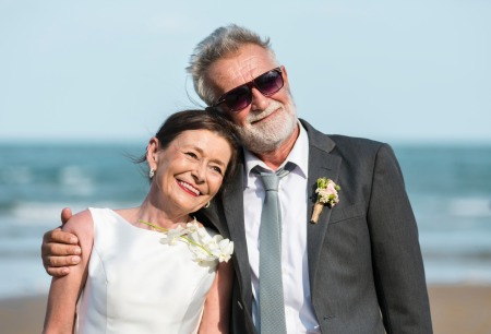 An older couple getting married at the beach.