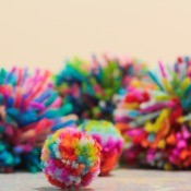 A collection of brightly colored pom poms.