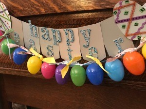 Making a Plastic Egg Garland - garland hung with the banner made earlier