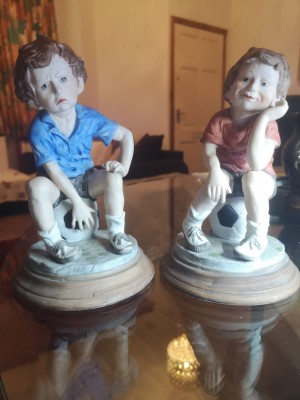 Value of a Pair of Leonardo Collection Figurines - figurines of a boy and a girl sitting on blue and white tuffets