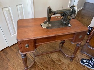 Value of a Vintage White Sewing Machine and Cabinet - black and brass vintage machine in a lovely wood cabinet