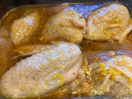 chicken added to marinade pan