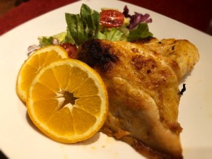 Spicy Orange Garlic Chicken with salad on plate