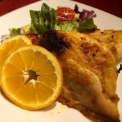 Spicy Orange Garlic Chicken with salad on plate