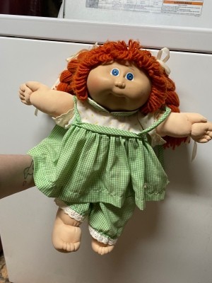 Value of a Cabbage Patch Doll - red haired doll wearing a green and white gingham dress