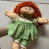 Value of a Cabbage Patch Doll - red haired doll wearing a green and white gingham dress