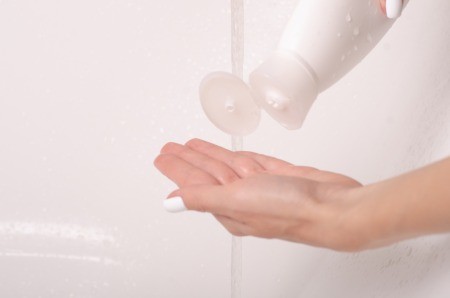 A bottle of shampoo being dispensed.