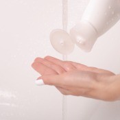 A bottle of shampoo being dispensed.