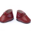 A pair of red doll shoes.