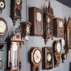 A wall of antique clocks.