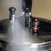 A pressure canner releasing steam.