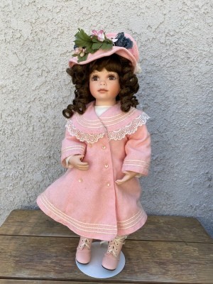 Value of an Ashton Drake Galleries Doll - doll wearing a light pink long coat with matching hat and shoes