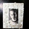 painted puzzle piece photo frame with a young boy's photo inside