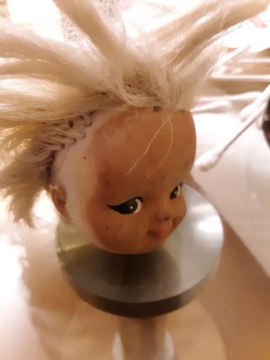 Cleaning Auto Wax and Grime Off of a Doll - stained doll's head