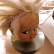 Cleaning Auto Wax and Grime Off of a Doll - stained doll's head