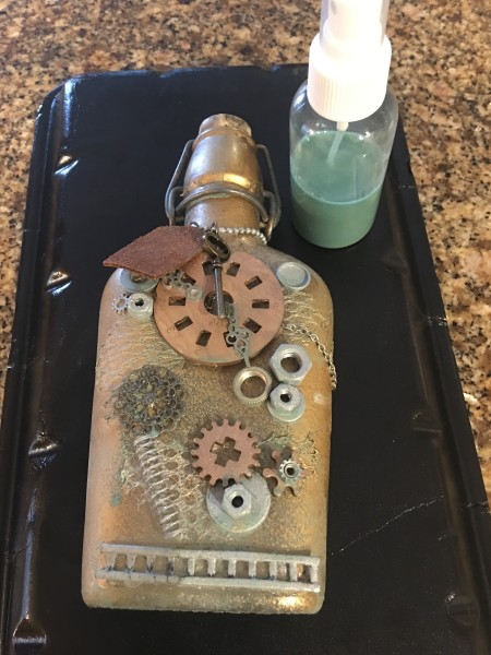 Steampunk Bottle - mix acrylic paint and rubbing alcohol to make and ink spray and apply to parts of the front and back of the bottle