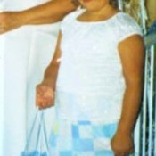 A flower girl in a white top and a handmade skirt.