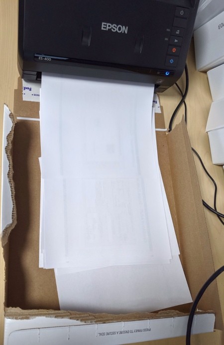 A cardboard box to use as a missing printer catch tray.