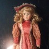 Value of a Porcelain Doll - doll in salmon colored dress and hat
