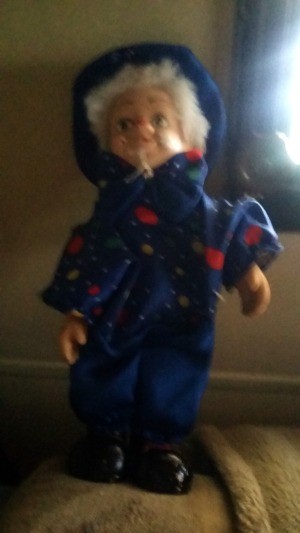 Value of a Musical Clown Doll - fuzzy photo of a doll wearing a dark blue outfit and hat