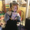 Value of a Porcelain Doll  - doll wearing a period dress, long skirt, striped puffy sleeves, and a lacy bodice