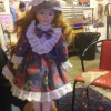 Value of a Porcelain Doll - doll wearing eyelet trimmed floral knee length dress