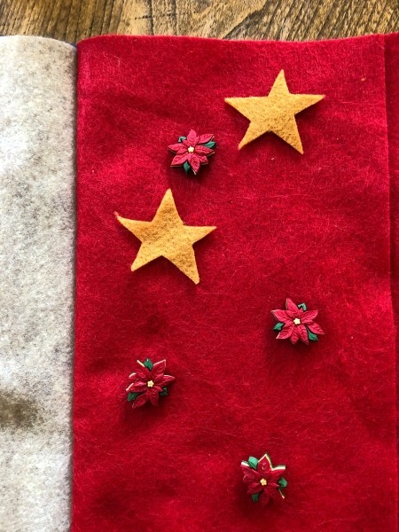 Child's Felt Book - layout of poinsettia buttons and two yellow felt stars