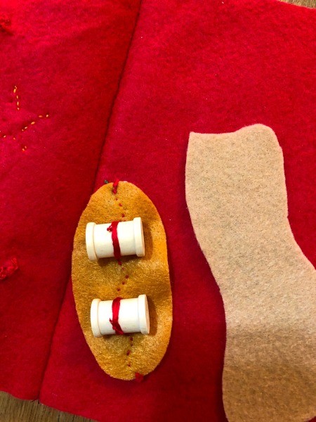 Child's Felt Book - underside of the skate board, showing spool wheels, tan sidewalk piece
