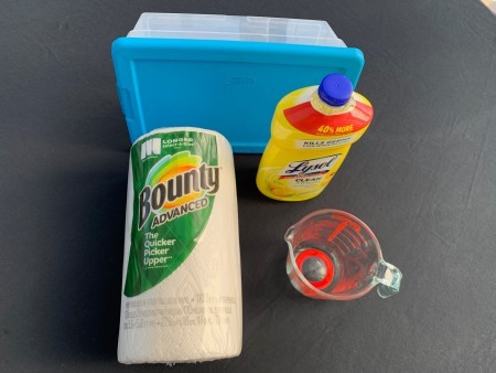 Supplies: paper towels, lysol, tub, measuring cup.