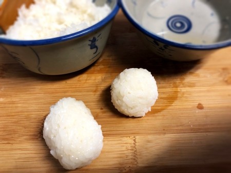 Making Animal Shaped Sushi - roll cooled rice into balls and press to pack it tightly together