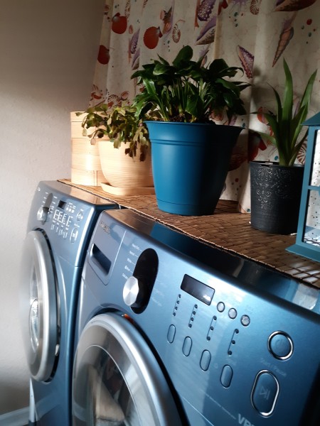 A table runner on top of a washer and dryer.