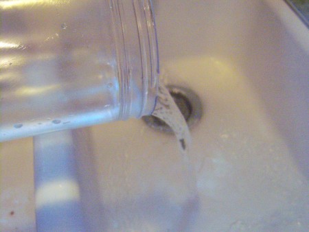 Removing Sticky Adhesive Residue from Plastic - pouring out water