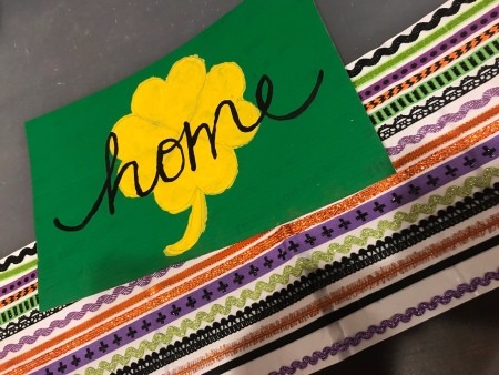 St. Patrick's Day Theme Hanging Wall Sign - sign lying on top of assorted sticker ribbon