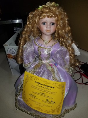 Value of a Knightsbridge Collection Porcelain Doll - doll with long curls wearing a lavender dress