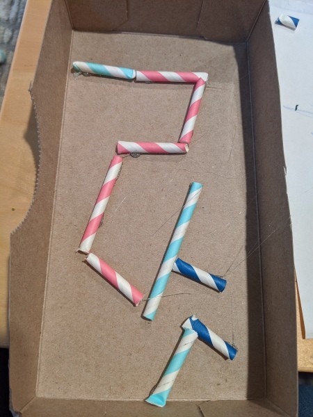 DIY Tissue Box Marble Maze - glue the straws in place