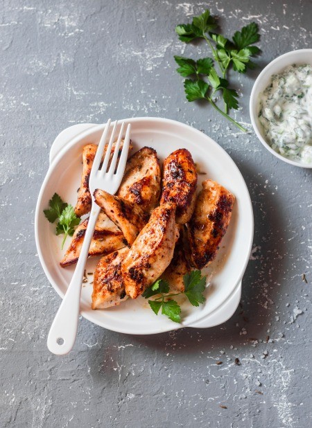 A plate of grilled marinated chicken.