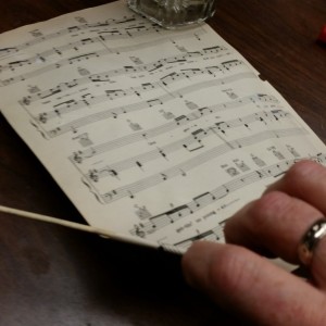 Recycled Mixed Materials Music Theme - rolling up a sheet of music