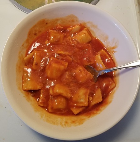 A bowl of pasta in tomato sauce.
