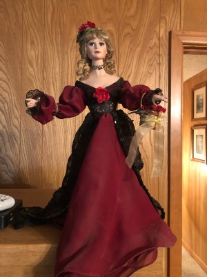 Identifying and Value of a Porcelain Doll - doll wearing a long dark red gown