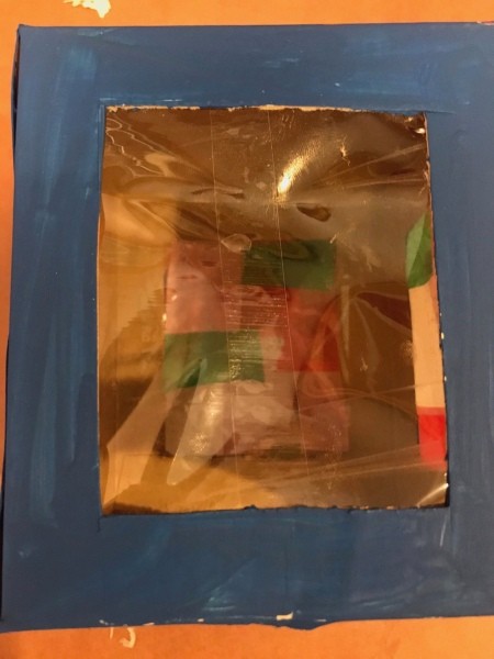 Kids DIY Cardboard Lantern - stick two pieces of packing tape together, then stick to the inside of the box with the sticky side out