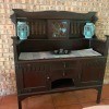 Value of an Antique Dining Room Cupboard - tall backed cupboard or sideboard, two drawers, and two doored areas below the main top with a small square storage area with a leaded glass door in the center of the backboard