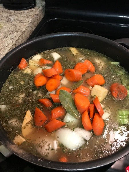 broth in skillet with veggies